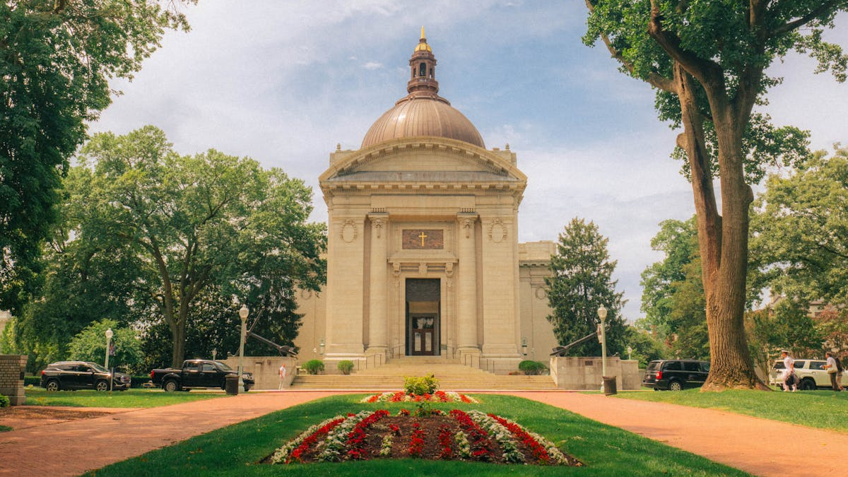 The Naval Academy Chapel in Annapolis, one of the historic highlights of Annapolis, surrounded by trees and a landscaped path